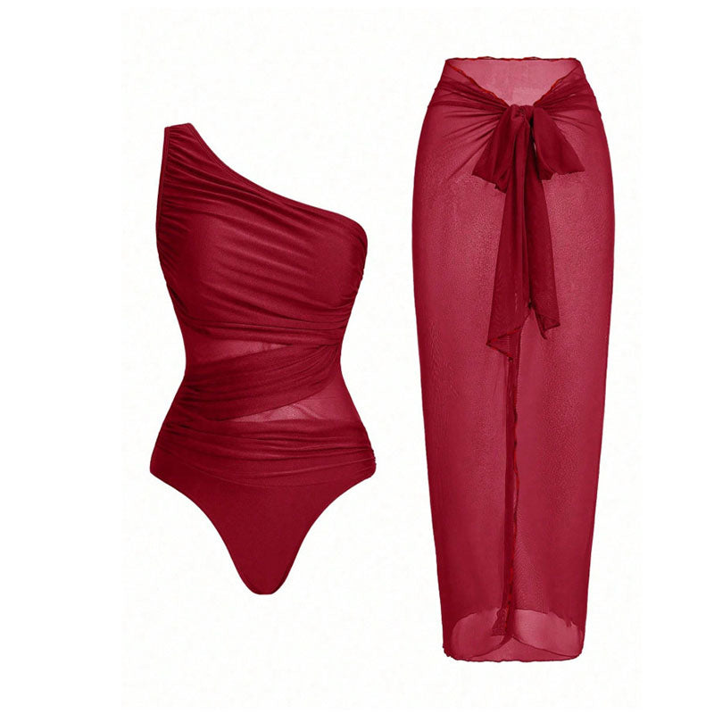 One-shoulder cut-out one-piece swimsuit and mesh cover-up skirt set